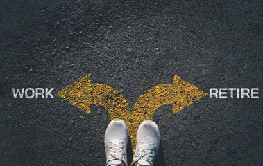 Career decision concept with work and retire arrows on asphalt road. Choice between employment and early retirement planning, life transition strategy and financial future direction with copy space.