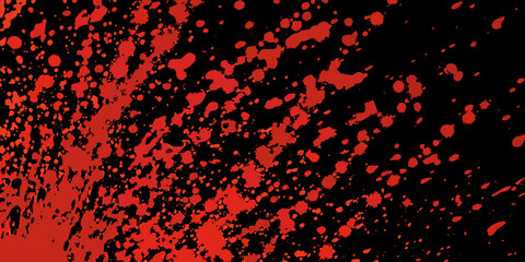 Abstract red splatter on black background resembling paint or liquid