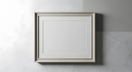 A blank picture frame hanging on a wall with a subtle shadow