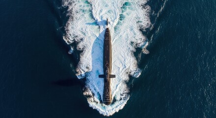 Aerial view of a large ship navigating through dark waters