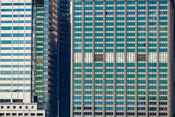 Facade details of modern office skyscrapers with glass windows in Lower Manhattan, New York City
