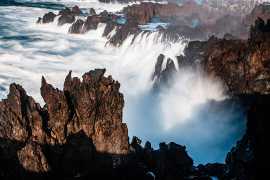 Waves crash against rocky shores in Porto Moniz, Madeira during a vivid display of nature's force