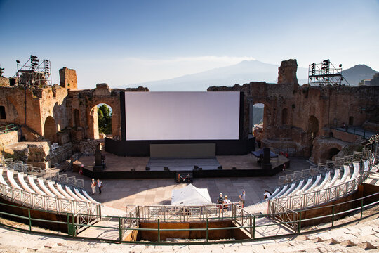 Empty white banner set up for an event in ancient theatre in Taormina, Sicily, Italy with Mount Etna in the background
