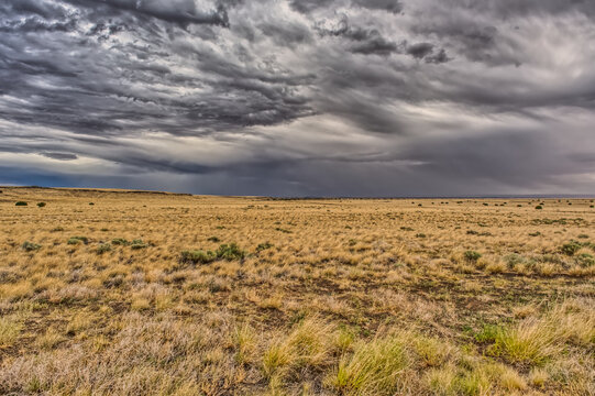 View of storm clouds rolling over prairie grassland in northern Arizona near Wupatki National Monument.