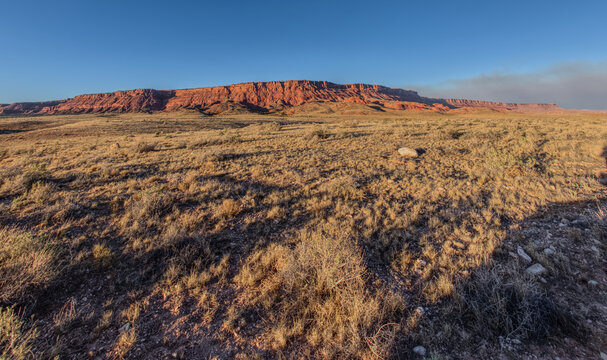 Vermilion Cliffs National Monument Arizona near sunset with smoke in the sky from the Dragon Bravo Wildfire, United States