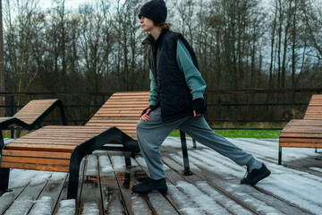 A teenager practicing side lunges during her outdoor workout. Daily routine of taking care of health and maintaining physical activity, emphasizing leg strength and flexibility.