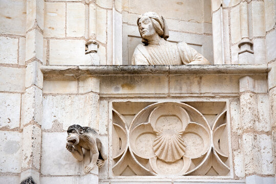 Statue (probably Jacques Coeur) on the balcony of a false window of the exterior facade of the Jacques Coeur's palace, Bourges, France