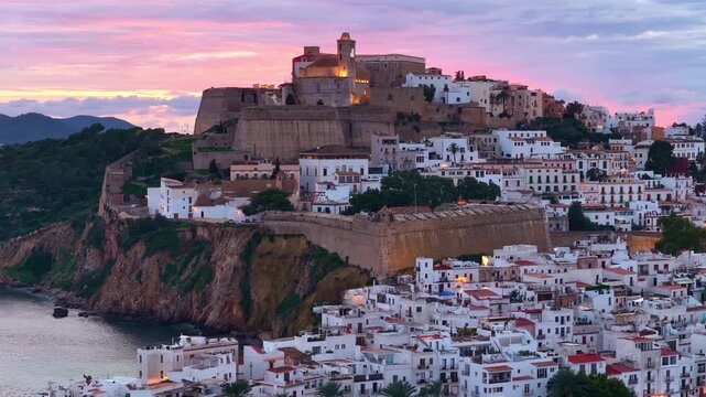 Sunset drone view of Eivissa castle in Ibiza, orbiting aerial view of the Almudaina historic old town, tourism on Ibiza island, Spain
