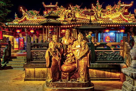 Bronze statues of the five Gods of Wealth at Guandi Temple at night (UNESCO World Heritage), Fujian Province, China