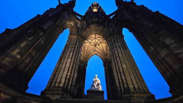 Sir Walter Scott Memorial stands tall against twilight sky in Edinburgh, Scotland, showcasing intricate architecture and historical significance
