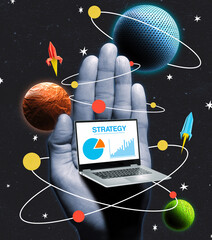 A hand holds an open laptop. Its screen displays charts and graphs. Around it are planets in their orbits and paper rocket models.