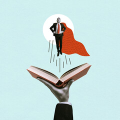 A young man in a superhero cape flies above an open book.