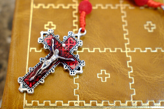 Old holy bible with a leather cover and a Rosary. Jesus on the cross. The crucifixion.
