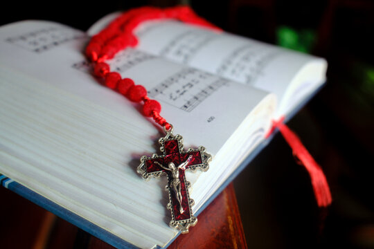 Catholic mass. Mass book with hymns and a Rosary. Kontum. Vietnam.