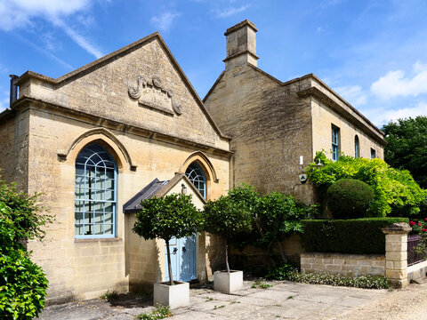 Former Baptist Chapel built in stone located in Farleigh Hungerford Somerset surrounded by plants and trees