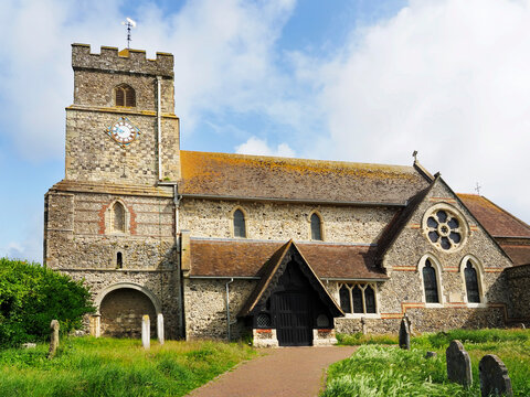 St Leonards Church in Seaford East Sussex with stone architecture and blue sky