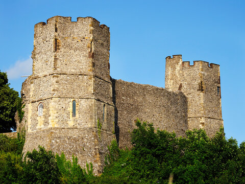 Sunset view of Lewes Castle in East Sussex with clear skies and green surroundings, highlighting stone structure and towers