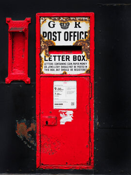 Post box on High Street in Old Town Hastings showing its history and design in East Sussex