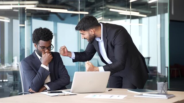 Angry boss standing at office desk shouting at employee with laptop. Furious manager expressing anger and dissatisfaction, showing stress, frustration in corporate workspace during business conflict