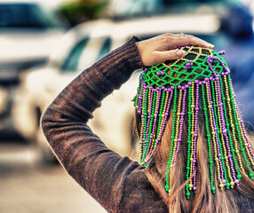 New Orleans, LA - February 9, 2016: Masked people along Mardi Gras Parade in Bourbon Street. Mardi Gras is the biggest celebration the city of New Orleans hosts every year © jovannig
