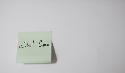 Self Care Reminder on Sticky Note on White Background