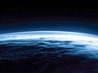 Fototapeta premium Stunning view of Earth?s horizon with glowing atmospheric layers and cloud formations illuminated by sunlight from outer space perspective