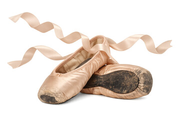 Worn pink ballet pointe shoes with ribbons