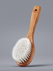 Wooden Baby-Faced Brush With White Bristles Gray Background