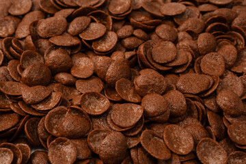 Corn-flakes background and texture. Chocolate cereal.