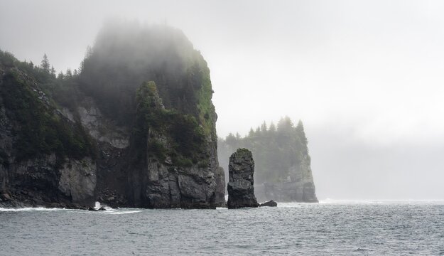 Mystical fog sweeps around rocky islands on the coast, Kenai Fjords National Park, Kenai Peninsula, Alaska, USA