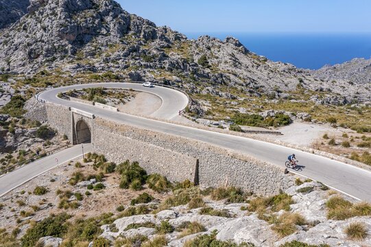 Road cyclists at the mountain pass with serpentines to Sa Colobra, Nus de Sa Corbata road loop, Serra de Tramuntana, Majorca, Balearic Islands, Spain