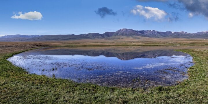 Mountains reflecting in a lake along the At-Bashy Range, Naryn Region, Kyrgyzstan