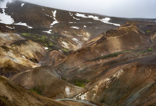 Steaming streams between colourful rhyolite mountains in the Hveradalir geothermal area, Kerlingarfj&ouml;ll, Icelandic Highlands, Iceland