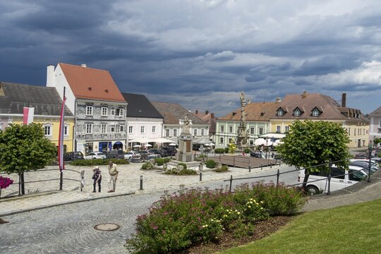 Town hall square with storm clouds and sgraffito house, Weitra, Lower Austria, Austria