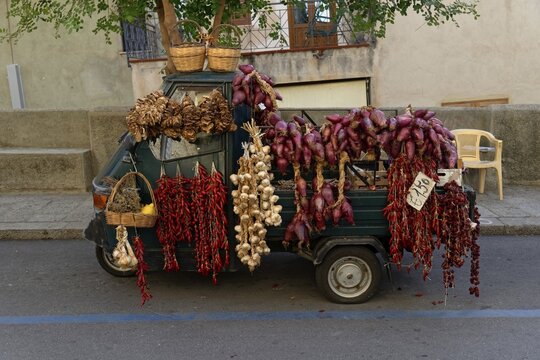 Piaggio tricycle van as a sales stand with onions and herbs, Tropea, Vibo Valentia, Calabria, Southern Italy, Italy