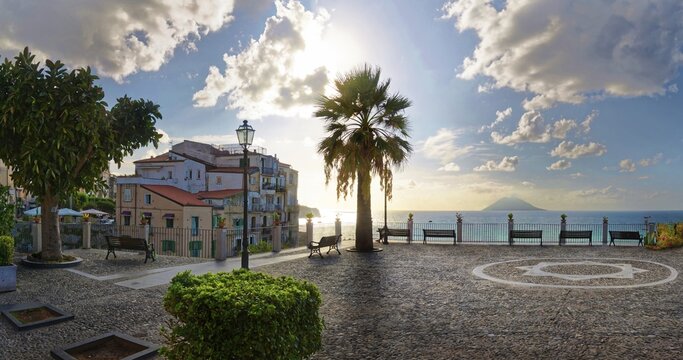Belvedere Piazza del Cannone town square with the sun at its lowest and the Stromboli volcano in the sea in the distance, Tropea, Vibo Valentia, Calabria, Southern Italy, Italy