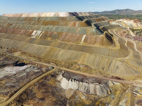 Mining waste dump and extremely mineral-rich ground and rock, scarred by the open-cast mineworkings of the Rio Tinto mines, at the town of Minas de Riotinto, aerial view, drone shot, Huelva province, Andalusia, Spain