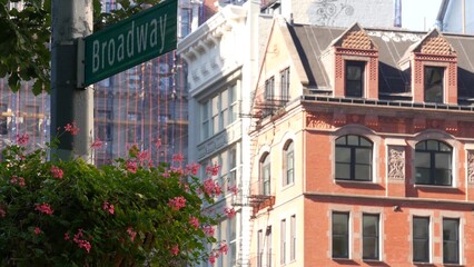 Fototapeta premium New York City Broadway street sign on Manhattan, United States. Urban road sign in american city. Traffic sign in Midtown. Building architecture in Flatiron district. Crossroad with 5 fifth avenue.