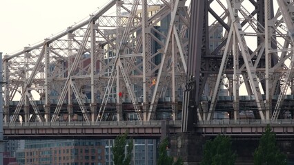 New York City Manhattan Midtown skyline from Queens, Queensboro bridge architecture, United States. Cityscape from rooftop in Long Island, Hunters Point. Urban sunset over transport metallic bridge.