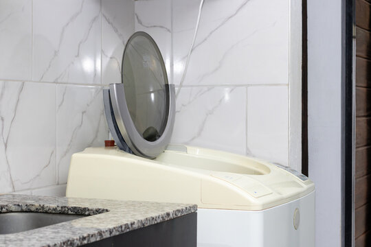 Open Top-Loading Washing Machine in Domestic Setting