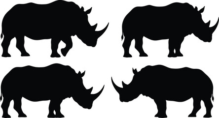 Four black silhouettes of rhinoceroses on white background © mdtaher