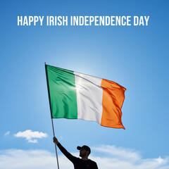 Man Holding Ireland Flag Under Blue Sky for Independence Day