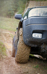 Off-road vehicle driving on a gravel road in a natural landscape. Powerful SUV ready for adventure and outdoor exploration. © jarizPJ