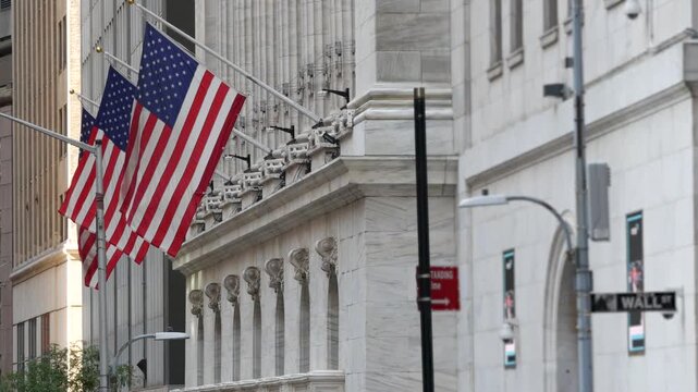 New York City Lower Manhattan Downtown Financial District, United States. Wall Street sign, stock exchange market building 1903, FiDi. American USA flag on facade. Trading finance and business concept