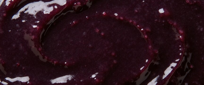 Dark purple blueberry jam or puree swirl texture macro top