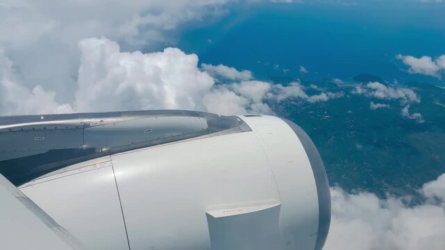 View from the plane window on plane engine flying ove the tropical islands in Indonesia