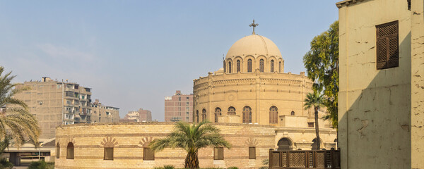 Historic church St. George in Coptic Cairo with domed sanctuary and urban surrounding buildings
