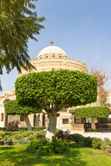 Historic church St. George in Coptic Cairo with domed sanctuary and urban surrounding buildings
