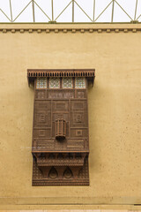 Traditional wooden mashrabiya window on a yellow wall &mdash; pictures made in Cairo, Egypt