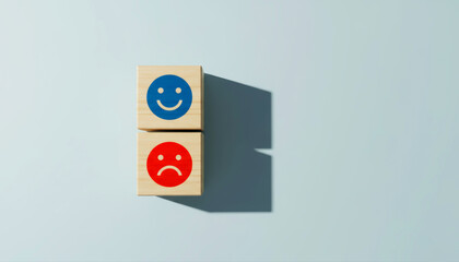 Concept of Mood Swing and Emotional Contrast with Happy and Sad Face on Wooden Blocks